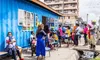 A group of people wait to receive health services outside of a mobile clinic in a remote community in sub-Saharan Africa. 